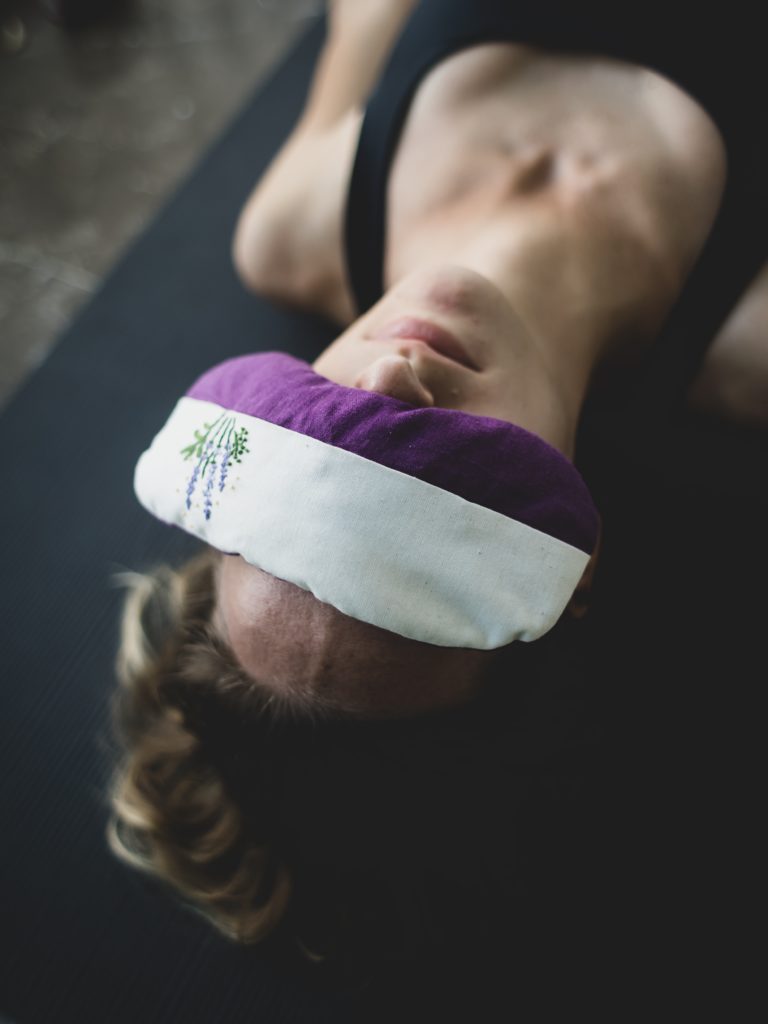 stock image woman with eye pillow